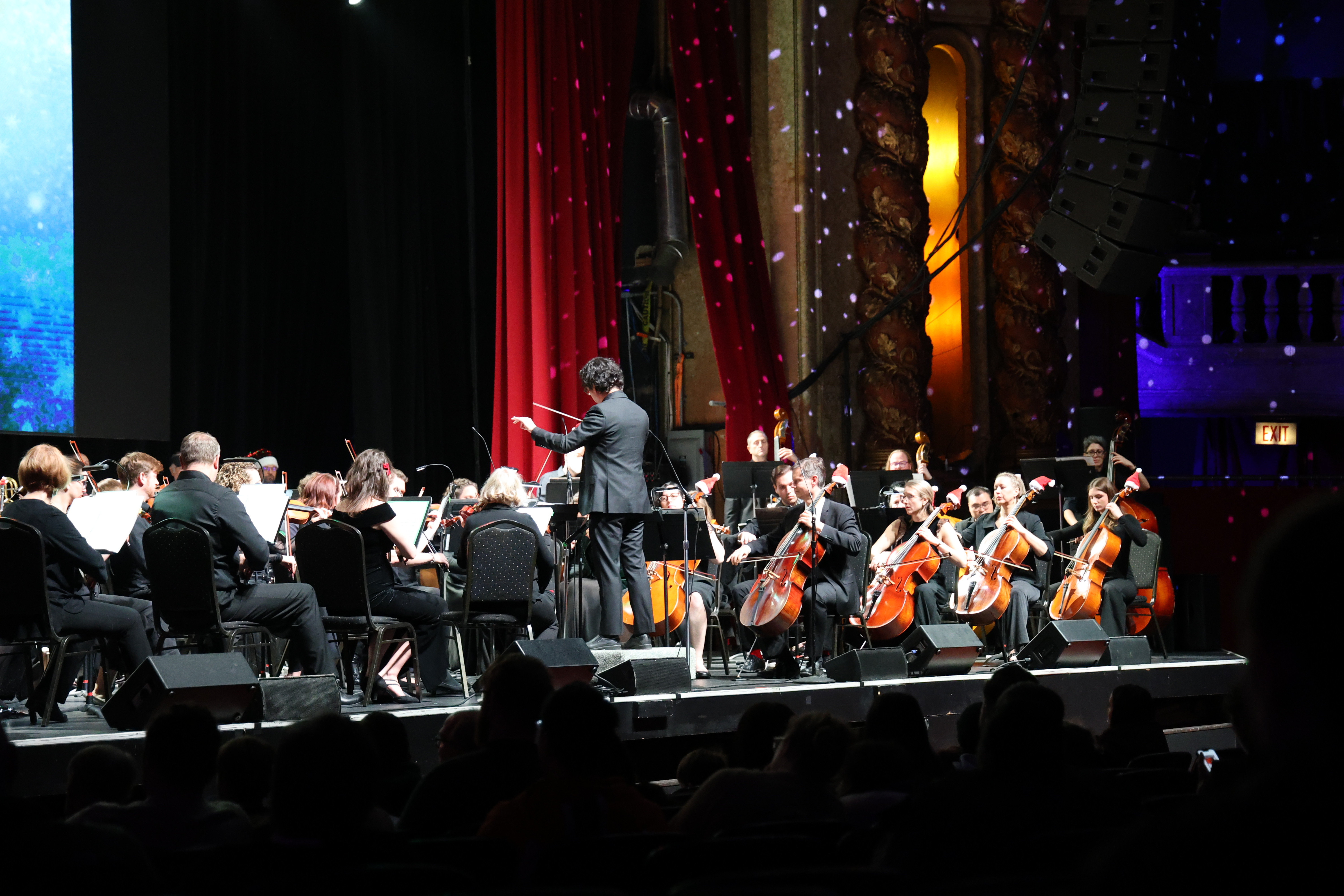 Photograph of an orchestra performing on stage.